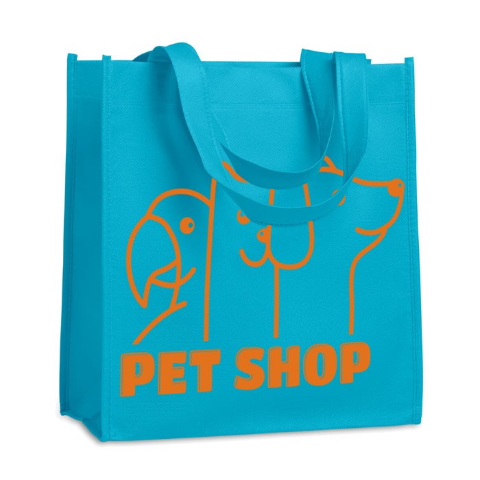 A shopping bag made from nonwoven material that has been heat sealed for durability. It comes with short handles for easy carrying. - Skipton