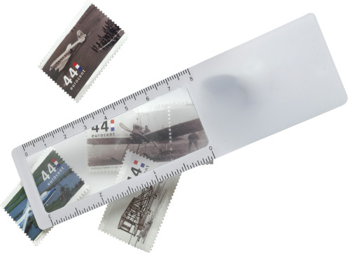 A bookmark made of plastic that also features a ruler and a magnifier - Charnwood