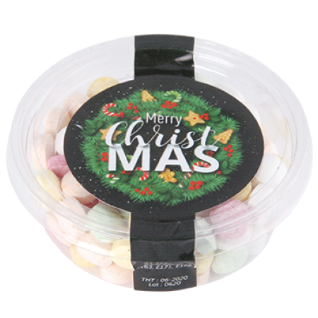 A clear, eco-friendly container filled with mints, fruit-flavored spheres, and heart-shaped candies - Oakthorpe